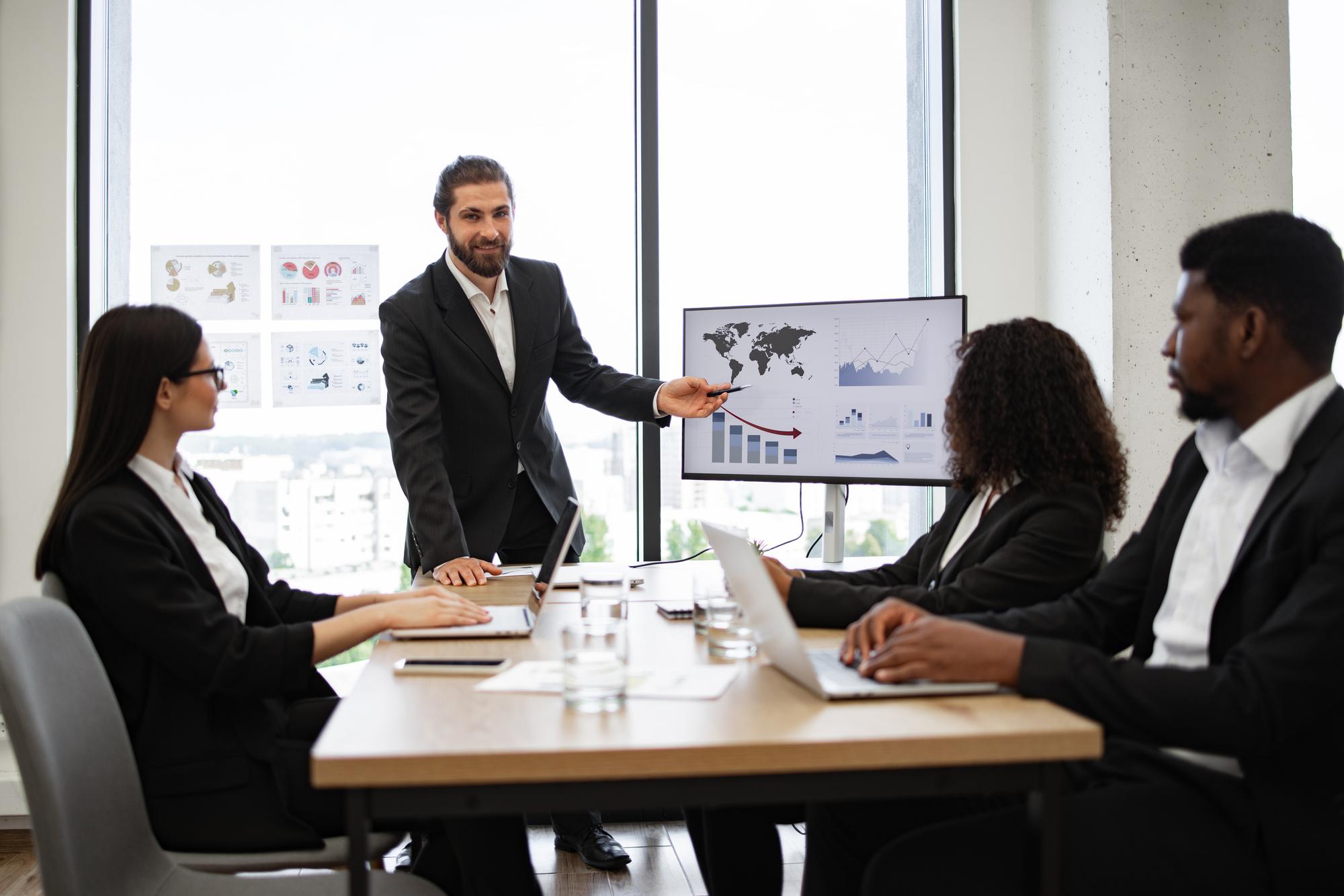 Consulting professionals reviewing company performance data and operational benchmarks